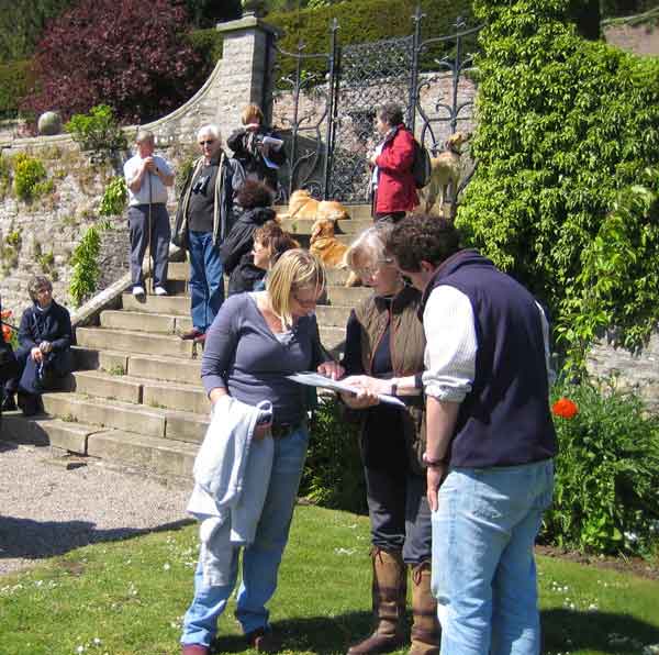 People in a garden at Bolton Abbey, North Yorkshire, being trained in how to record historic gardens.